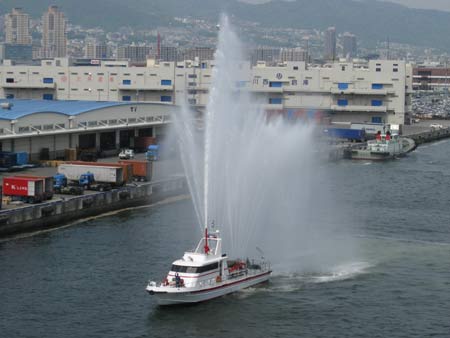 fireboat welcomes cruise liner to kobe